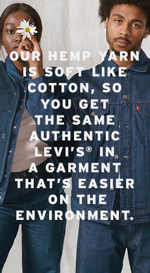 Image Description: The image background is an image of two people wearing double denim outfits from the Wellthread collection. The person on the right is holding a white and yellow daisy flower in front of the left person's eye. There is white text that reads: 'Our hemp yard is soft like cotton, so you get the same authentic Levi's in a garment that's easier on the environment.'